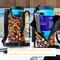 Two purple and yellow swirl print water bottle bags are pictured bags holding a 40 ounce Owala tumbler. One bag displays the lining.
